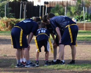 Calvary Christian School boy's flag football team in a huddle