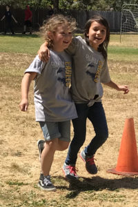 Two girls in a relay race at Calvary Christian School