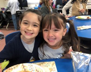 Two girls from Calvary Christian School eating lunch in the cafeteria